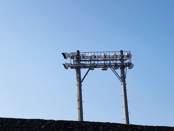 Low angle view of old tower against clear blue sky
