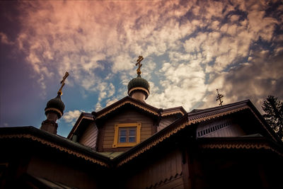 Low angle view of building against cloudy sky