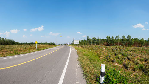 Empty road along countryside landscape