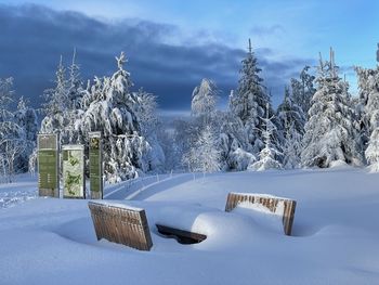 Scenic view of snow covered field against sky