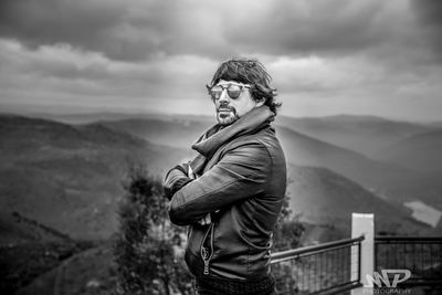 Man standing by mountain against sky