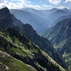 Scenic view of valley and mountains against sky