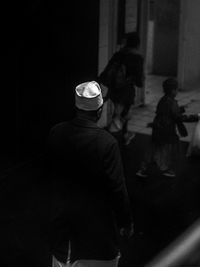 Rear view of people walking at night