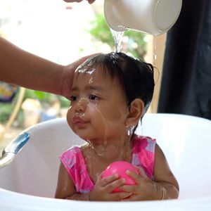 Close-up portrait of cute baby boy in water