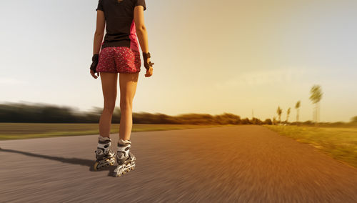 Rear view of woman walking on road