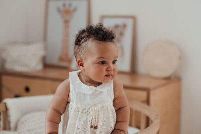 Portrait of cute girl sitting at home