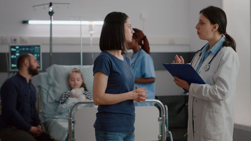 Woman talking to doctor at hospital