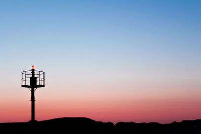 Scenic view of silhouette mountains against sky during sunset