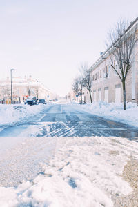 Street full of ice after a heavy snowfall with cars buried under the snow. winter season. 