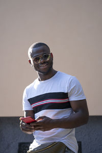 Man with sunglasses using mobile cell phone.