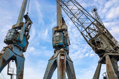 Low angle view of crane against sky