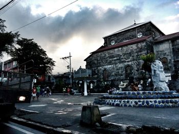 Low angle view of building against cloudy sky