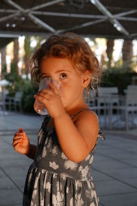 Close-up of cute girl drinking water
