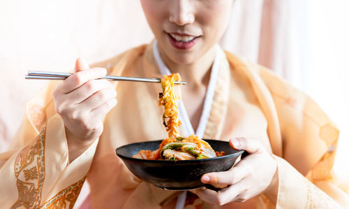 Midsection of woman eating food