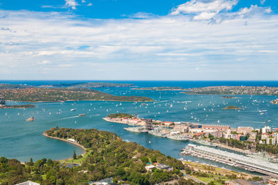 High angle view of sea and townscape against sky