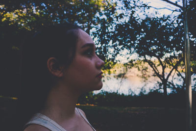 Side view of thoughtful young woman looking away