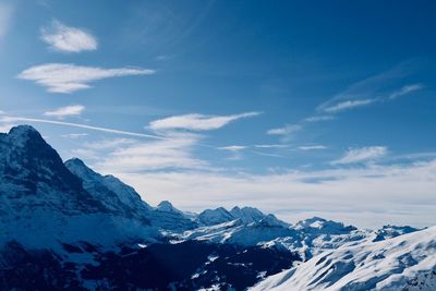 Scenic view of snowcapped mountains against blue sky