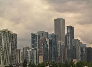 Modern buildings against cloudy sky