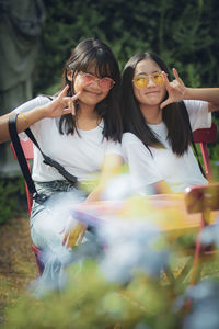 Portrait of smiling girls sitting outdoors