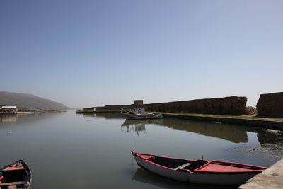 Boats moored in calm lake