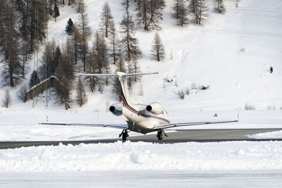 A private jet is ready to take off in the airport of st moritz switzerland in winter