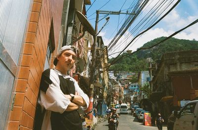 Low angle view of young man standing in favela vidigal