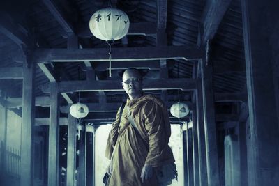 Low angle view of statue against illuminated building