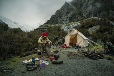 Hunter sitting in front of tent