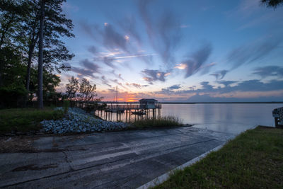 Scenic view of lake against sky at sunset