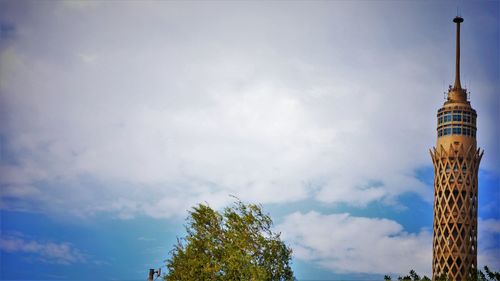 Low angle view of building against cloudy sky