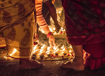 Low section of people standing at illuminated temple