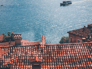 High angle view of townscape by sea against sky