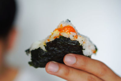 Close-up of hand holding sushi