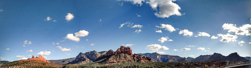 Scenic view of mountains against cloudy sky