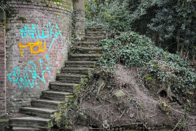 Graffiti on staircase against wall
