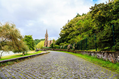 Panoramic view of temple amidst trees and buildings against sky