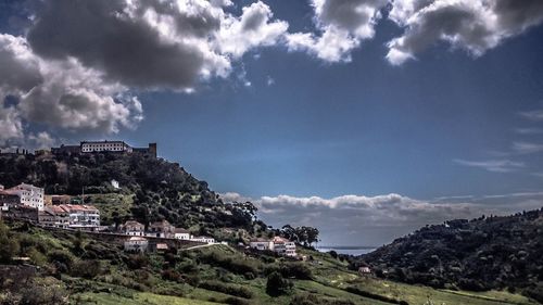 View of town against cloudy sky
