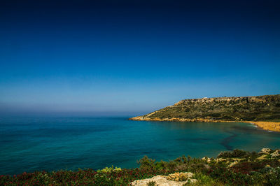 Scenic view of sea against blue sky