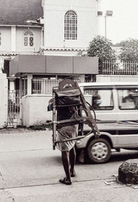 Full length rear view of man walking on street