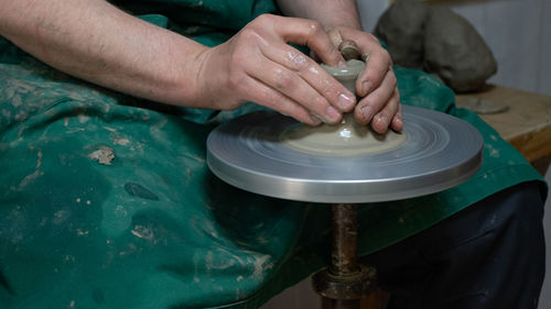 Midsection of man working at workshop