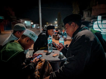 Side view of people playing at music concert