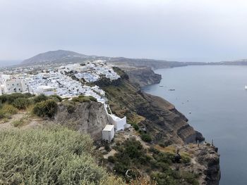 High angle view of buildings by sea against sky