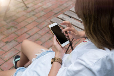 Midsection of woman using mobile phone