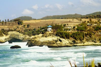 Scenic view of sea and landscape against sky