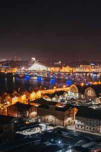 High angle view of illuminated buildings against sky at night