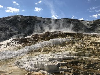 Scenic view of waterfall against sky