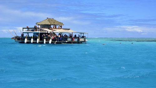 Built structure in sea against blue sky