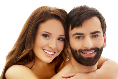 Portrait of a smiling young woman against white background