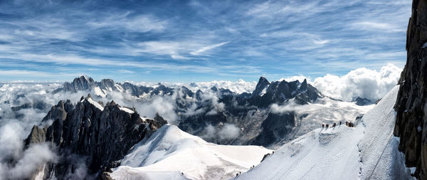 Scenic view of snow covered mountains against sky