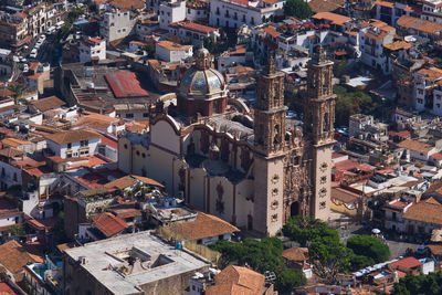 High angle view of buildings in city and santa prisca cathedral on taxco